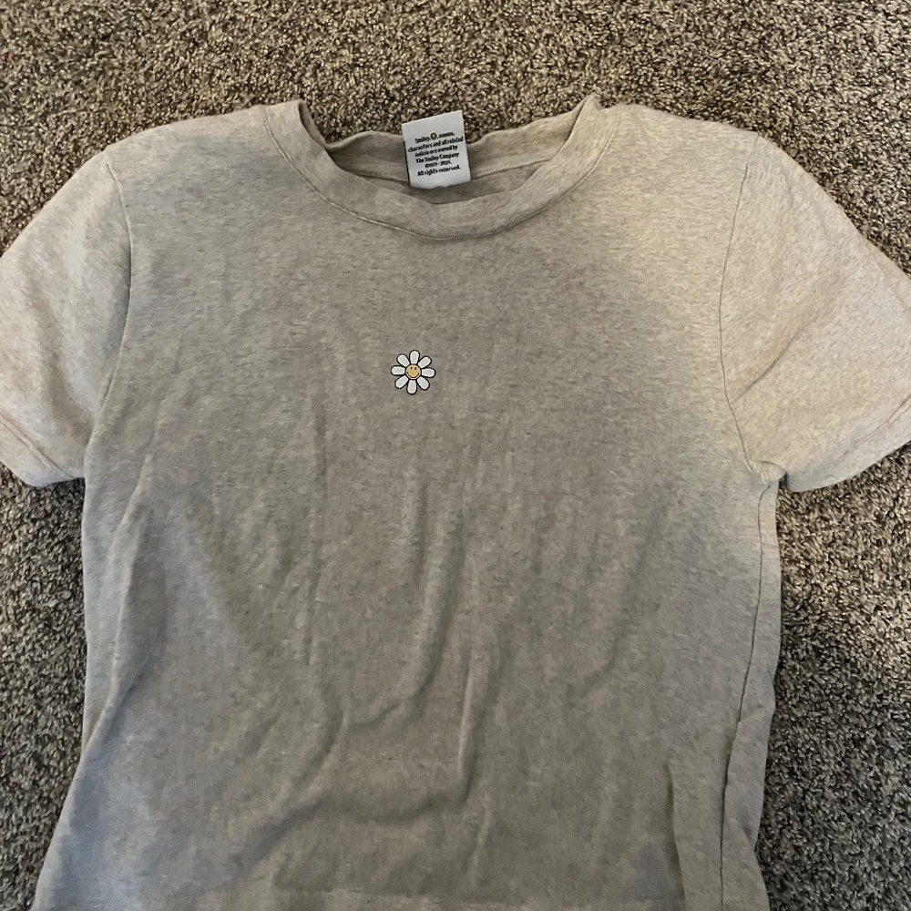 tan shirt with a flower